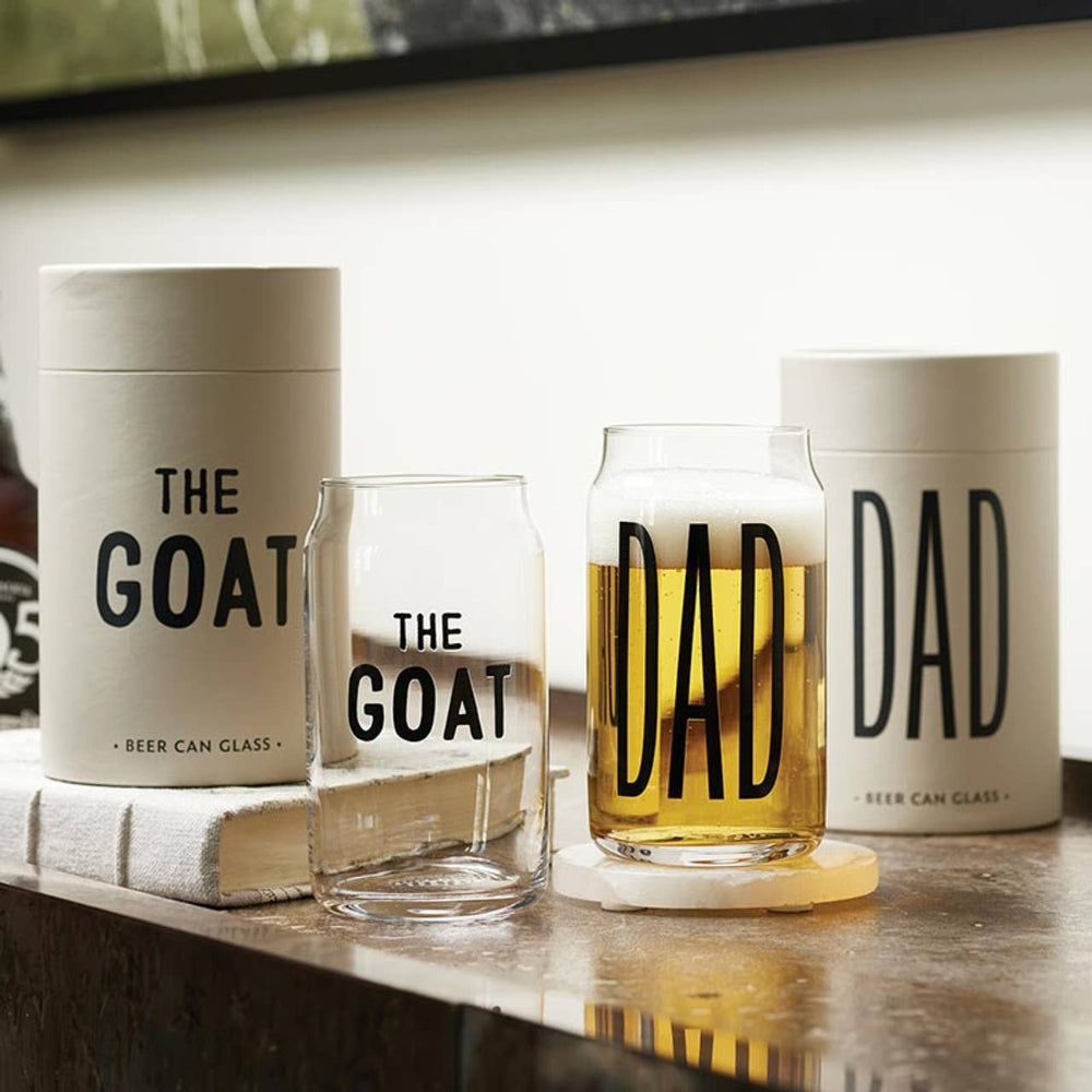 Beer can glasses with 'The Goat' and 'DAD' text on a wooden surface.