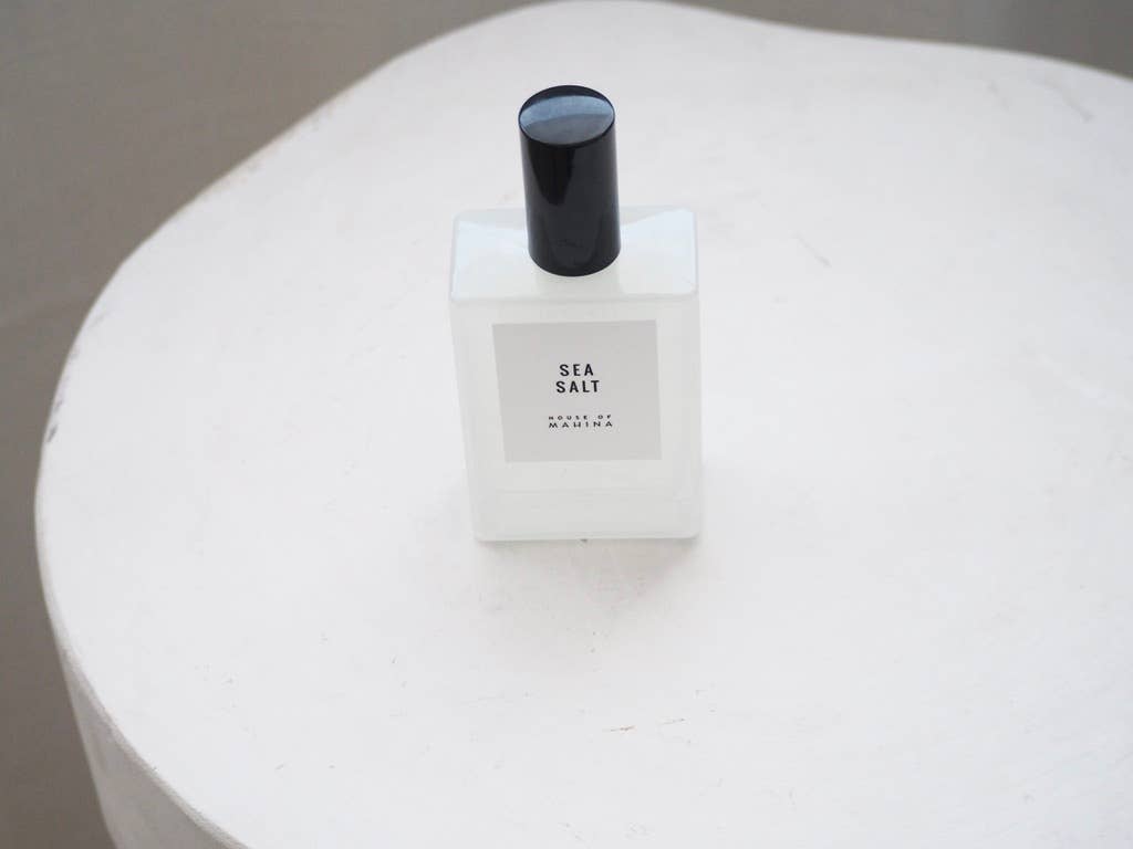 Sea Salt mist bottle with black cap standing on a white textured table