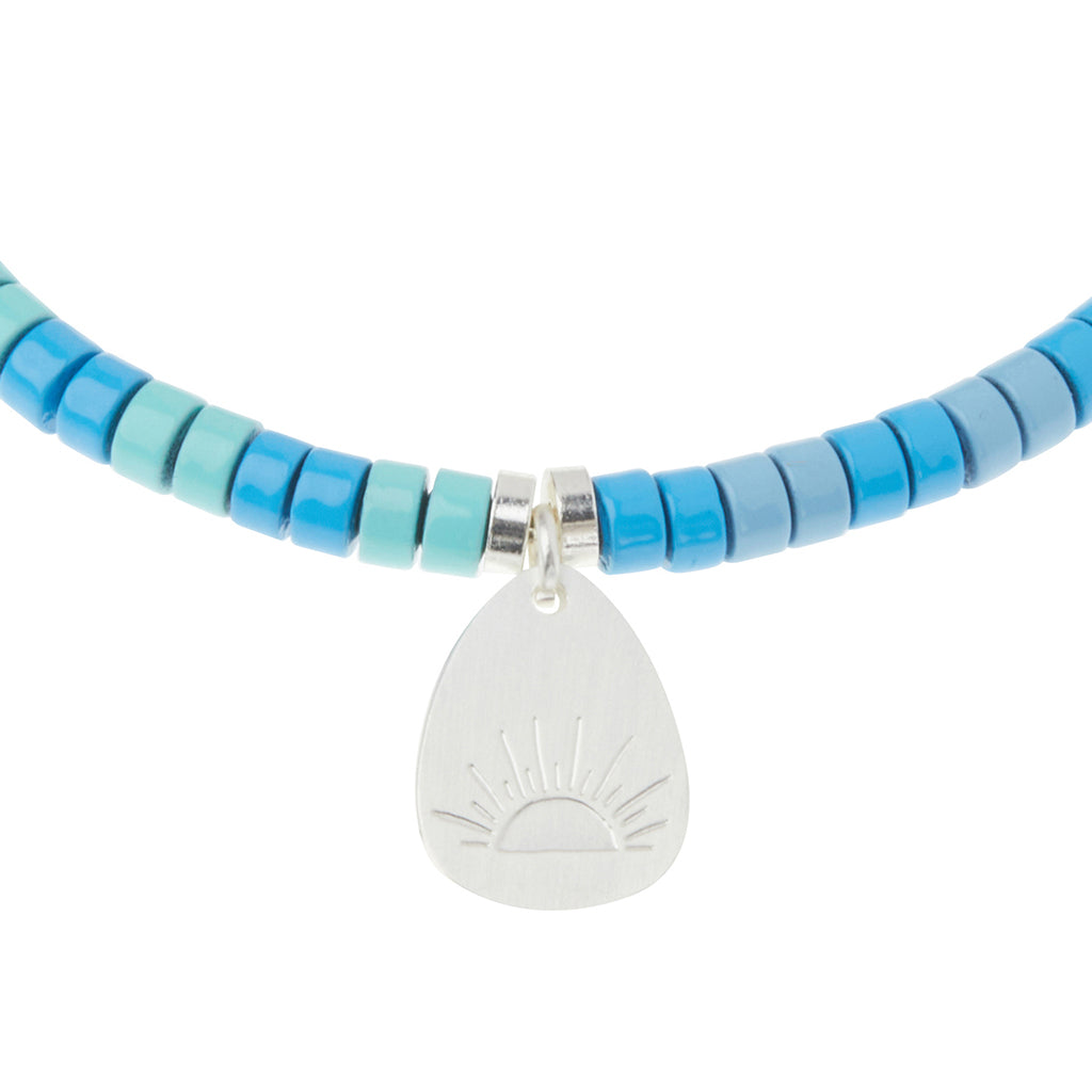 Scout Turquoise Charm Bracelet close-up of metal charm featuring the Harmony design