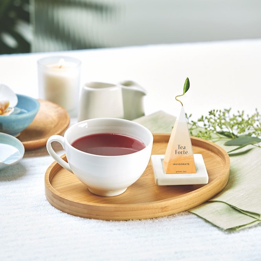 Cup of Well Being Tea from Tea Forte on wooden tray