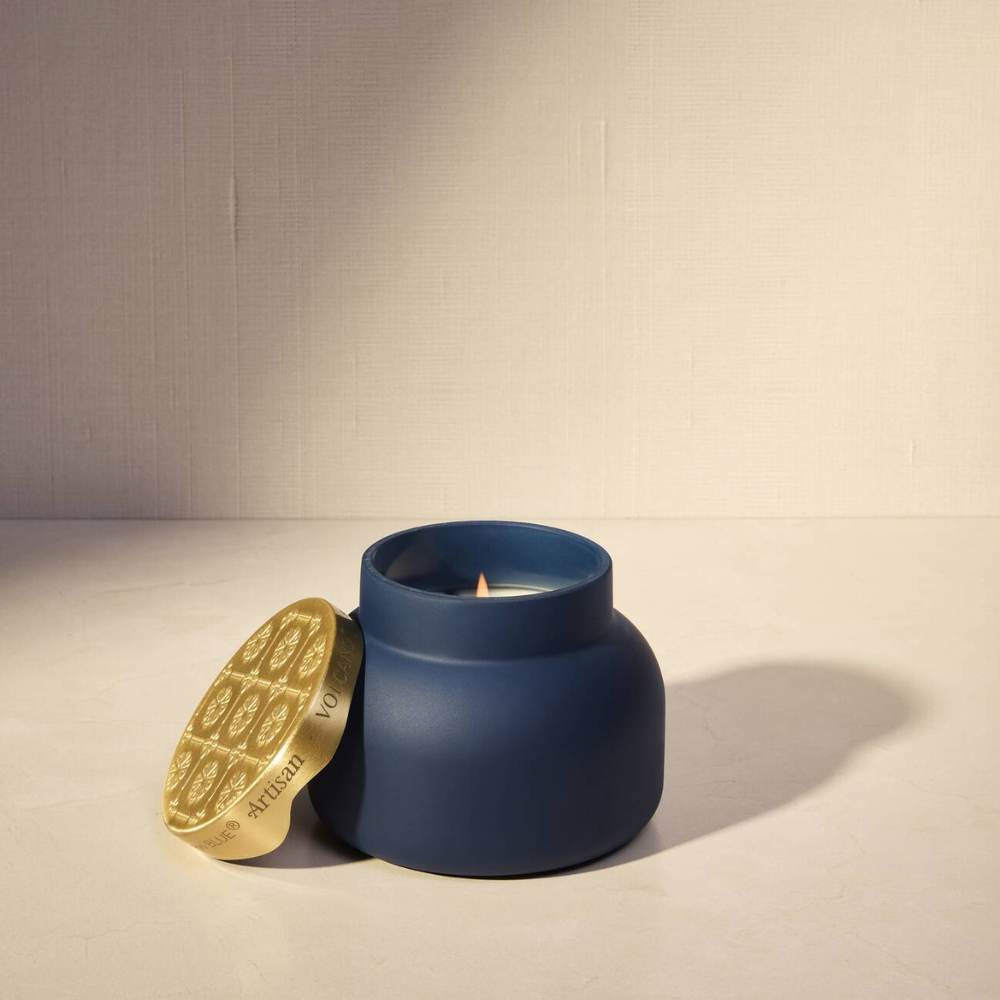 Lit Capri Blue Volcano Terrazza Velluto signature candle styled on a warm neutral surface