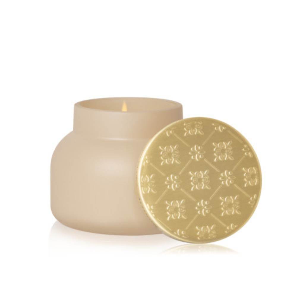 Lit Capri Blue Coconut Santal Terrazza Velluto signature candle, matte cream vessel and gold lid