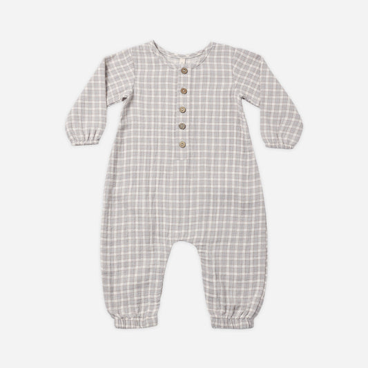 A baby long-sleeve romper in a light blue and white gingham check pattern, featuring a button-up front with wooden buttons.