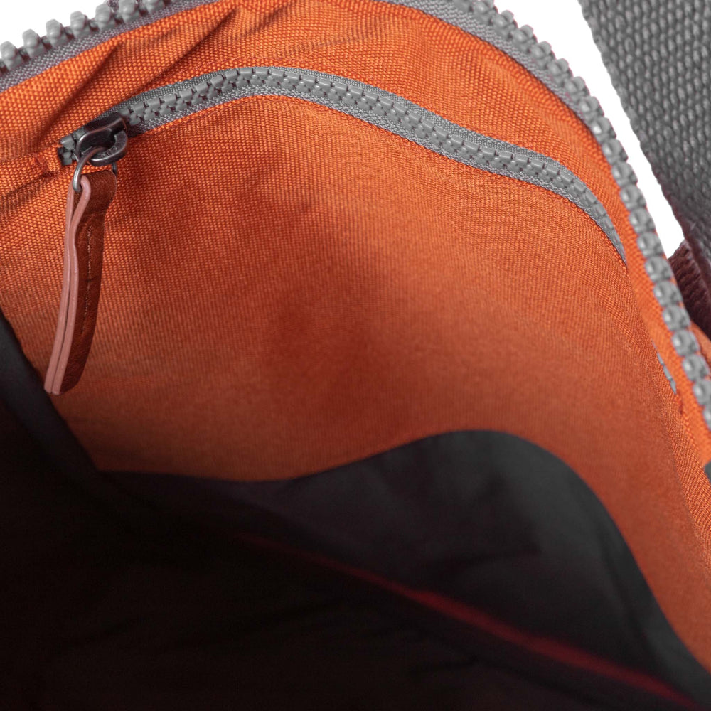 ORI London Atomic Orange Finchley backpack in recycled canvas with padded laptop sleeve and roll-top closure