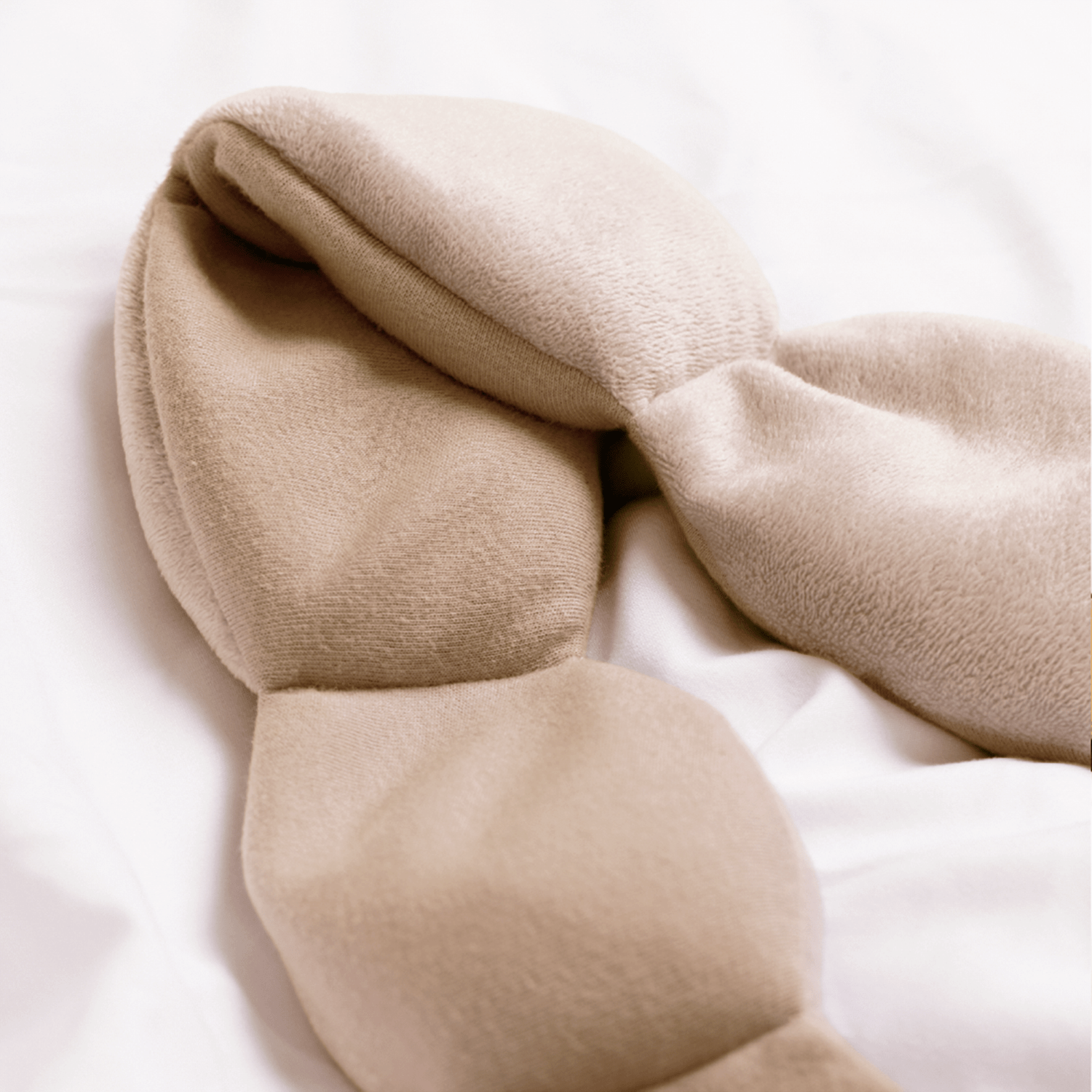 Nodpod Latte weighted sleep mask worn lying down for sleep