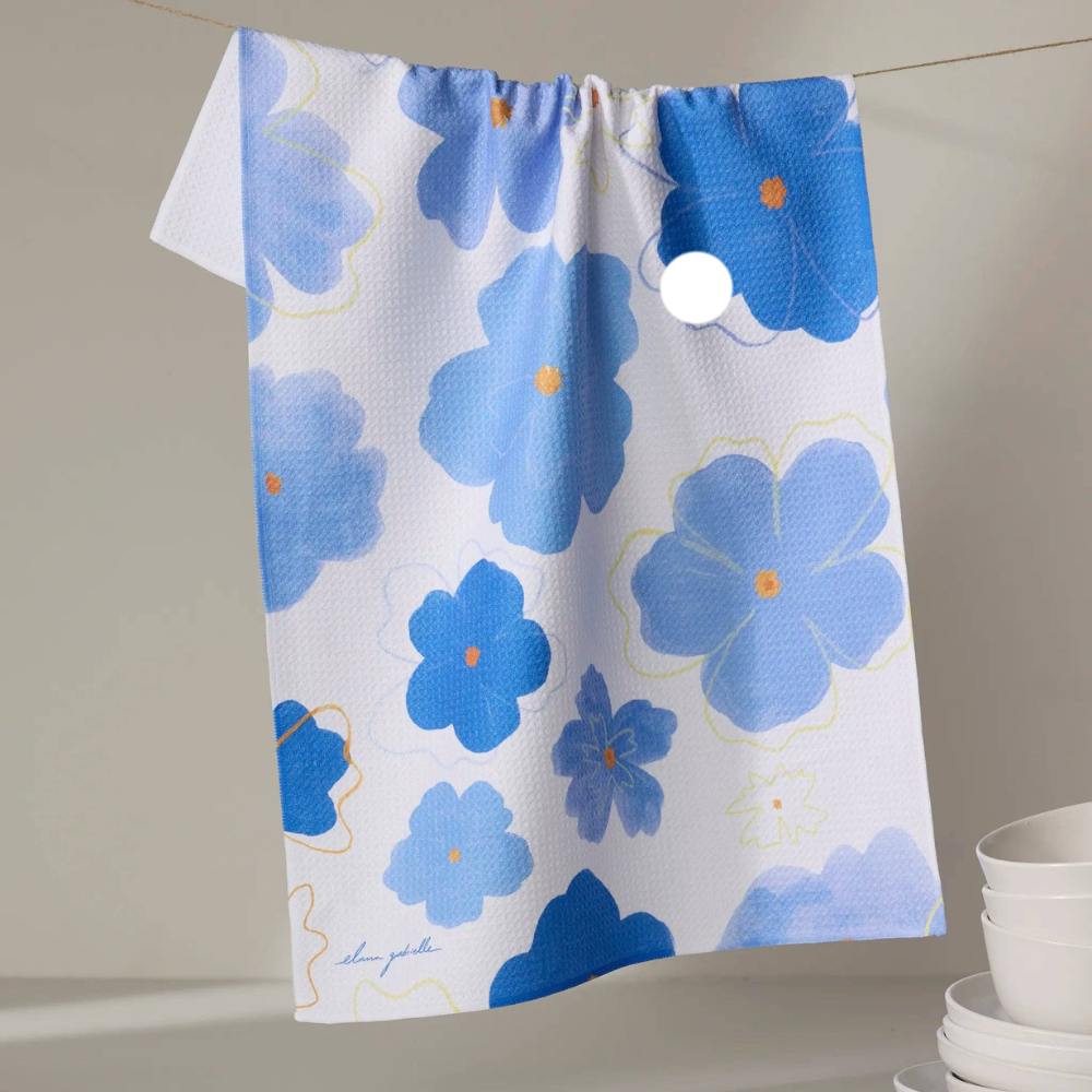 Blue floral patterned Geometry tea towel hanging on a rack with a neutral background
