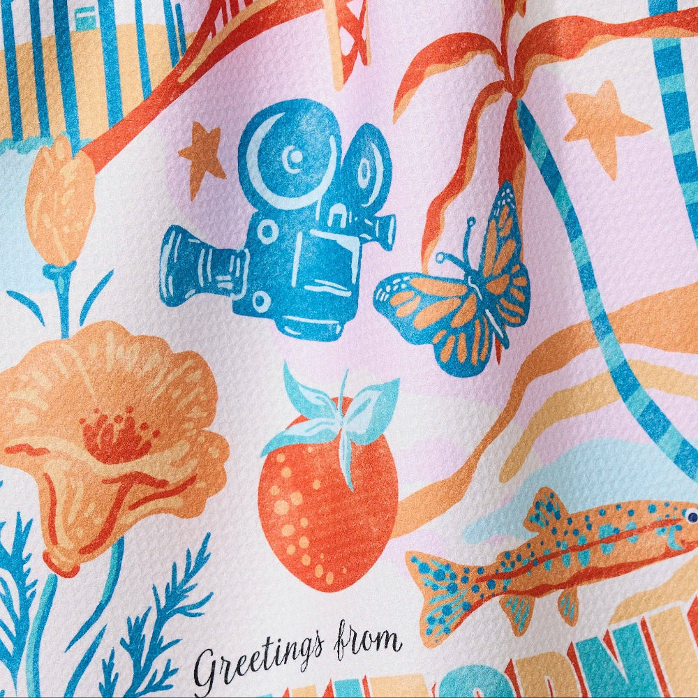 Colorful fabric with cartoon-like illustrations of a camera, butterfly, fish, and other elements on a light background.