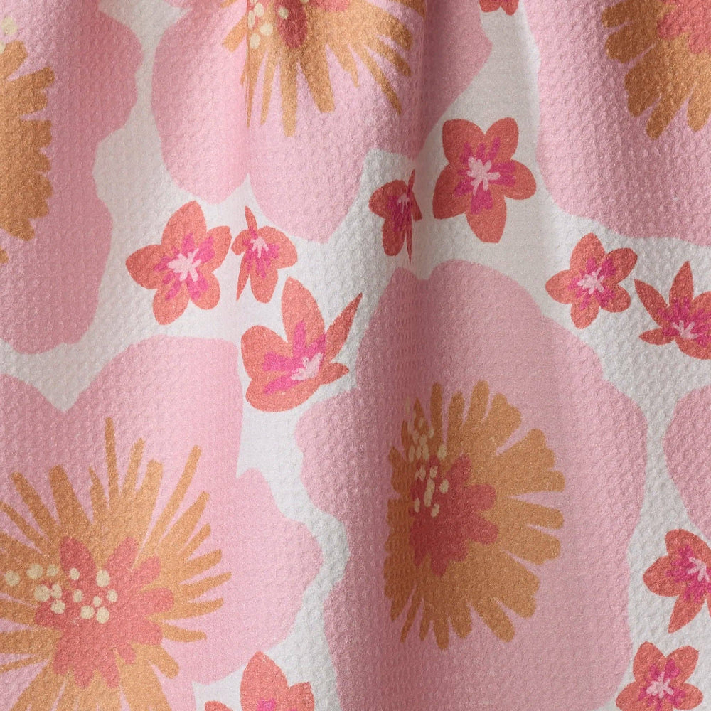 Floral patterned fabric on Geometry Hibiscus Tea Towel featuring pink and orange flowers on a light background