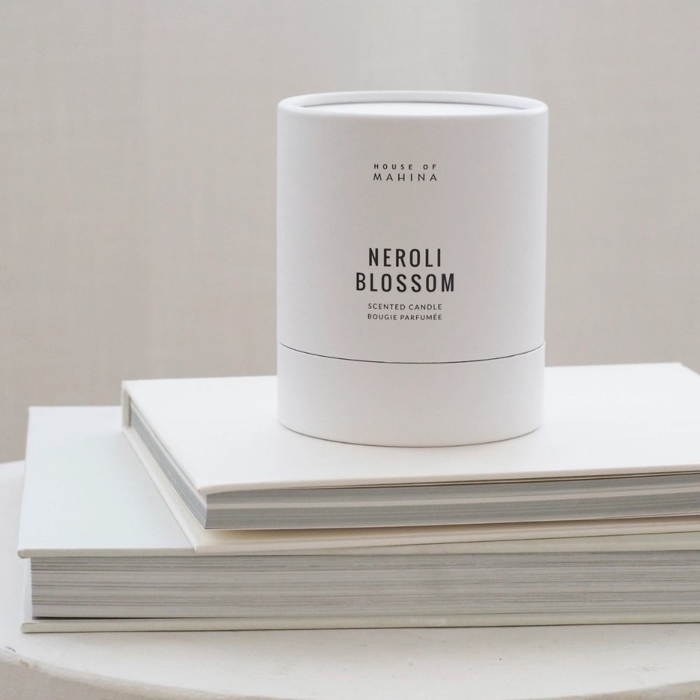 Neroli Blossom candle box on stack of white books  