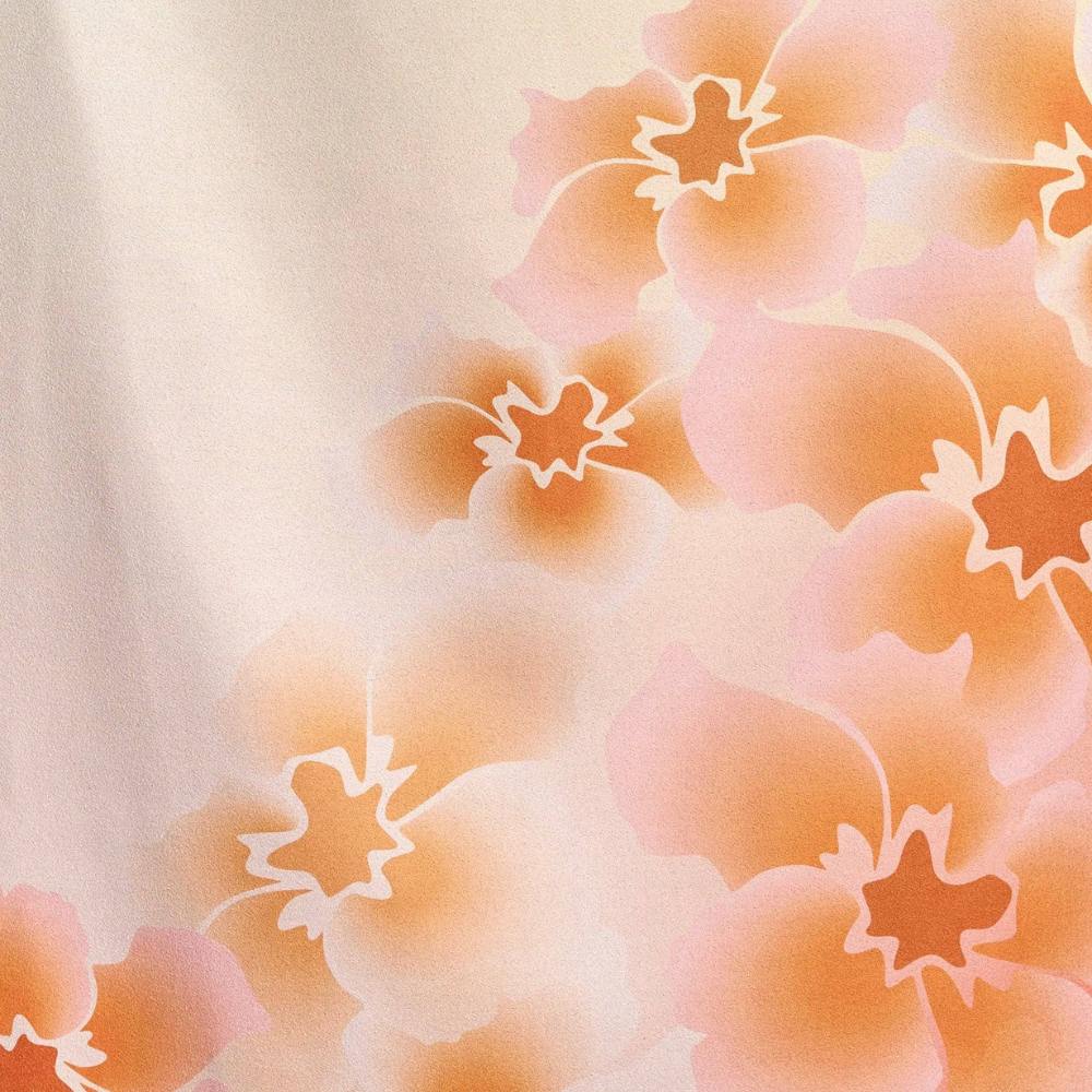 Fabric Sample of Nicole beach towel featuring a floral pattern with orange and pink flowers on a light background