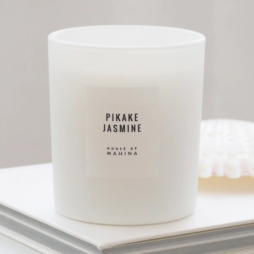 Pikake Jasmine candle on stack of white books
