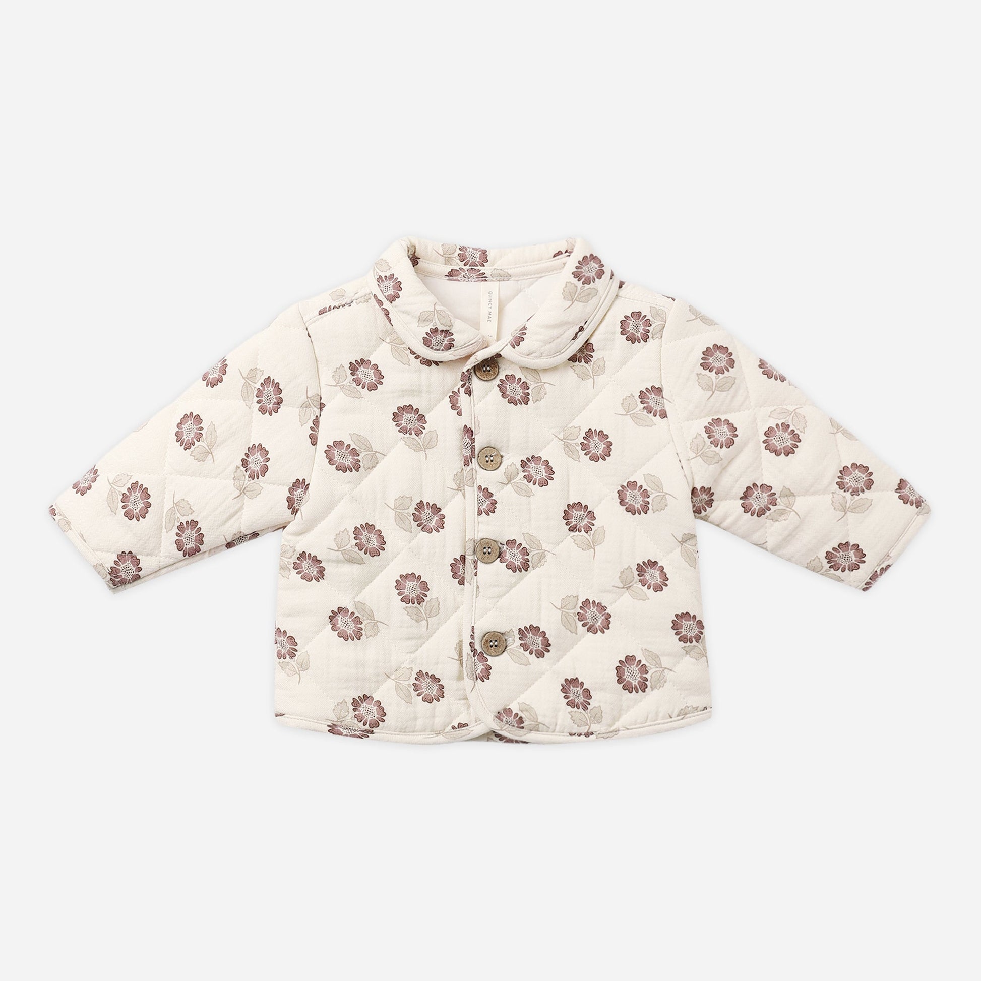 A quilted baby jacket in cream with a brown floral pattern, featuring a collar and button closure, laid flat on a light gray background.