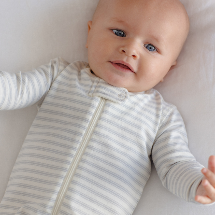 Quincy Mae Cloud Stripe Zip Sleeper Footie in organic brushed jersey, styled lifestyle photo