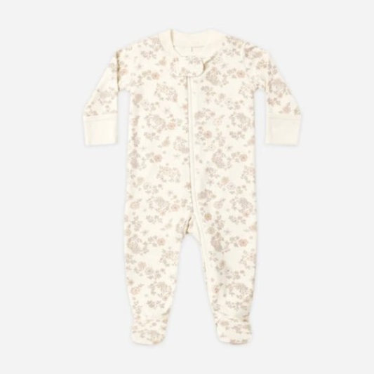 A baby long-sleeve footed sleeper in cream with a delicate beige floral pattern, featuring a front zipper closure.