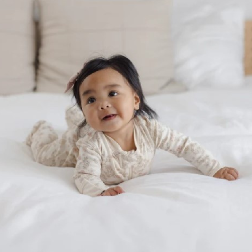 Quincy Mae Floral Vine Zip Sleeper Footie in organic brushed jersey, styled lifestyle photo