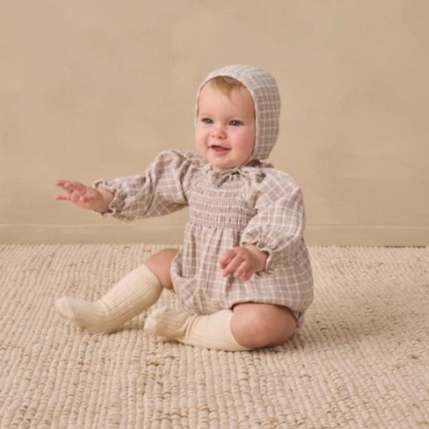 Quincy Mae Blue Gingham Eden Romper in organic cotton, styled lifestyle photo