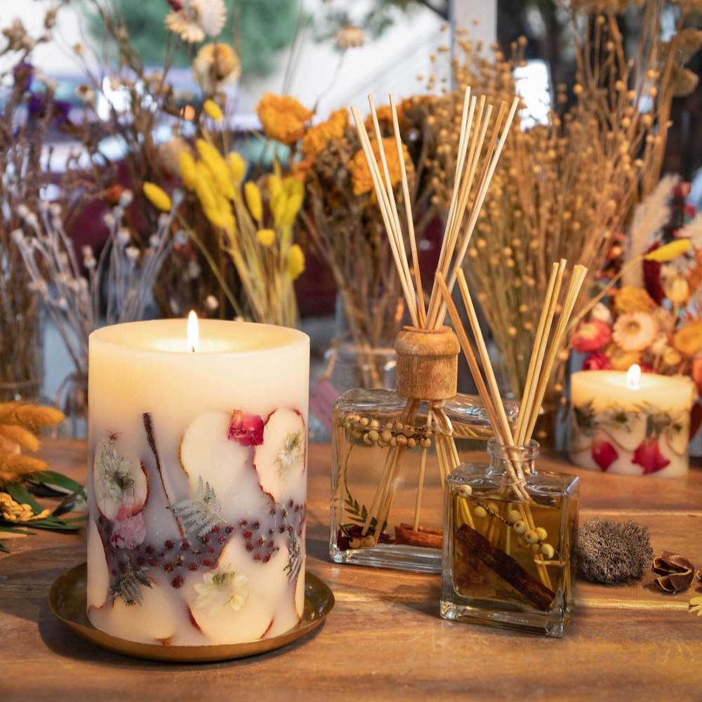 Spicy Apple botanical candle and spicy apple diffusers from Rosy Rings displayed on fall themed table