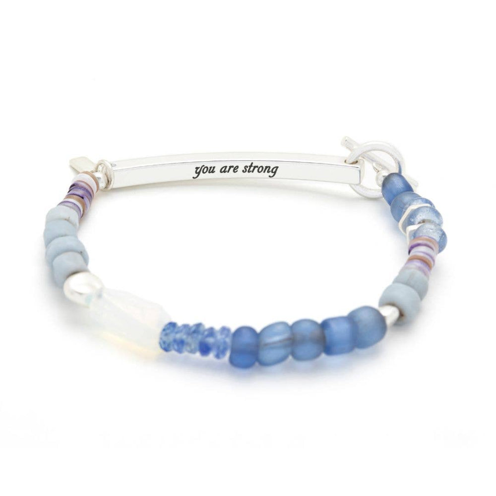 Bracelet with blue beads and 'you are strong' message on a white background