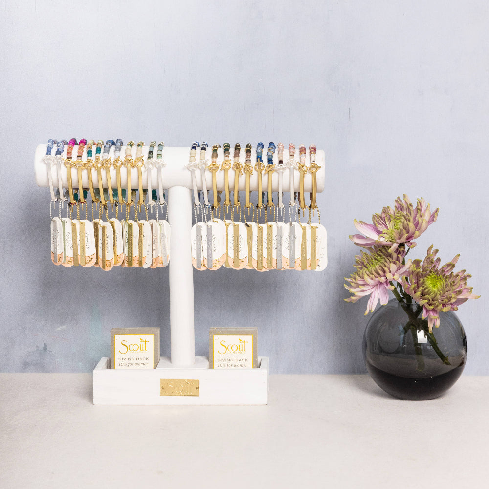 Colleciton of Scout Hidden Message bracelets hanging on retail display