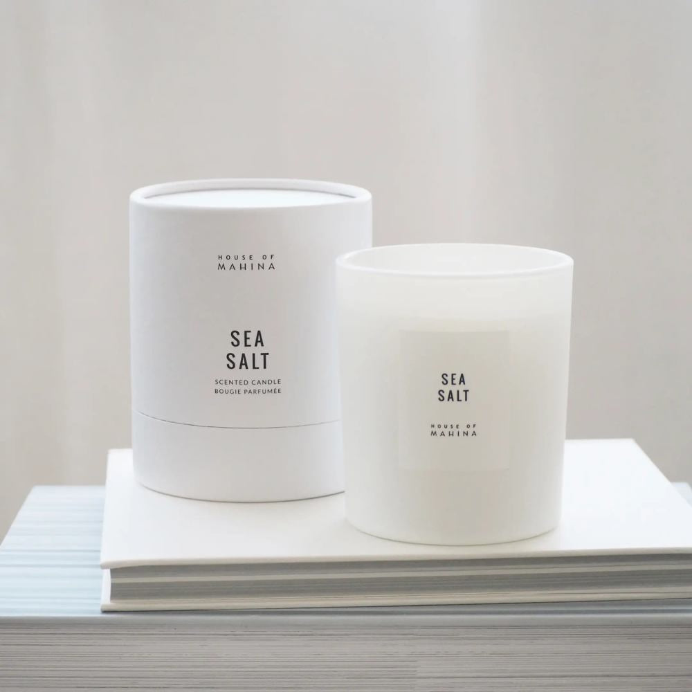 Sea Salt candle and round box  on stack of white books