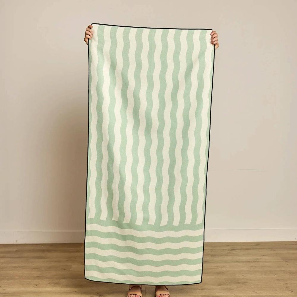 Person holding Serene Beach Towel made by Geometry