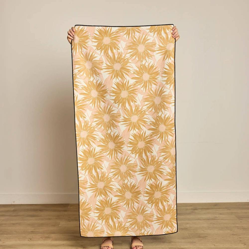 Person holding a Sundara Beige and Pink Beach Towel from Geometry