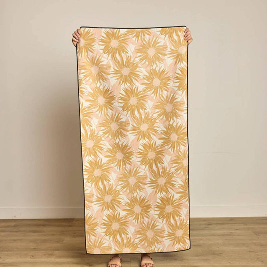 Person holding a Sundara Beige and Pink Beach Towel from Geometry