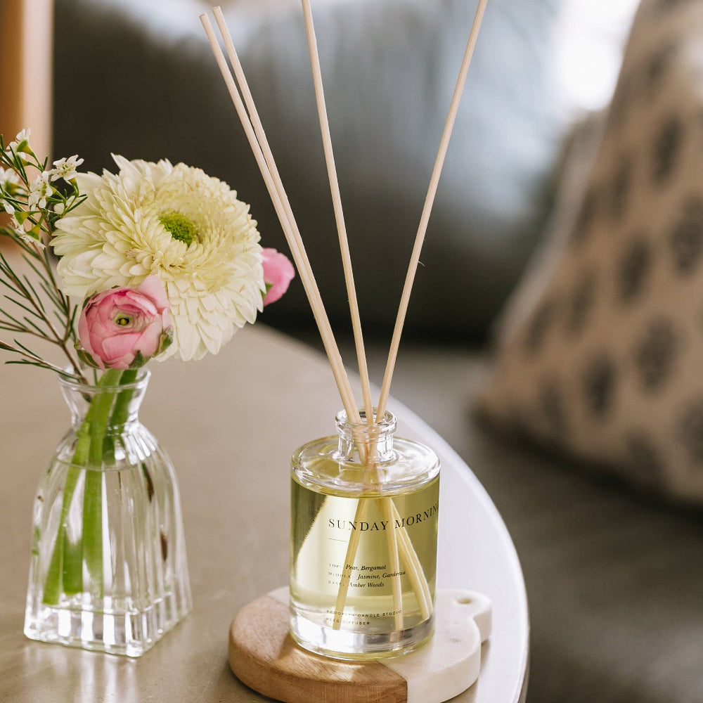 Sunday Morning reed diffuser with a small vase of flowers, pear and jasmine scent