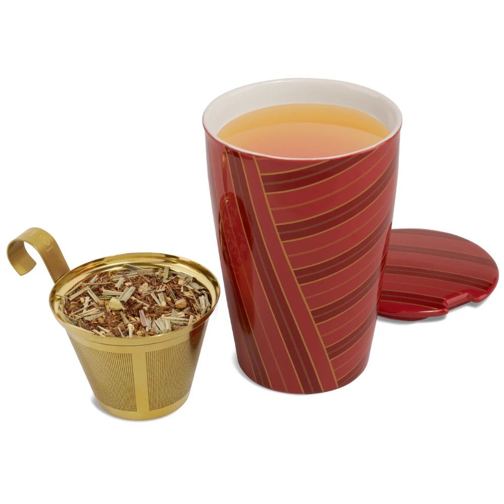 Tea Forte Warming Joy Kati cup in red stripes with tea, its lid and a gold infuser basket of loose tea