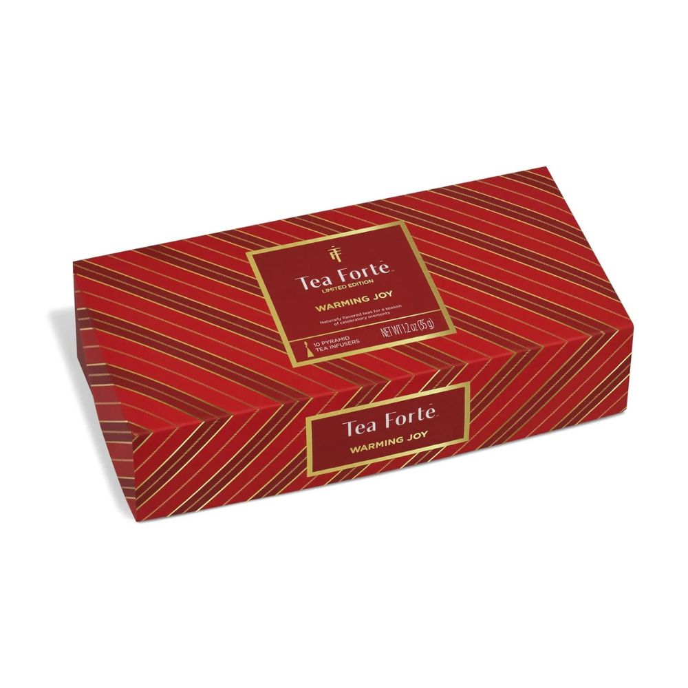 Tea Forte Warming Joy Petite Presentation Box, a closed red striped gift box with a gold framed label
