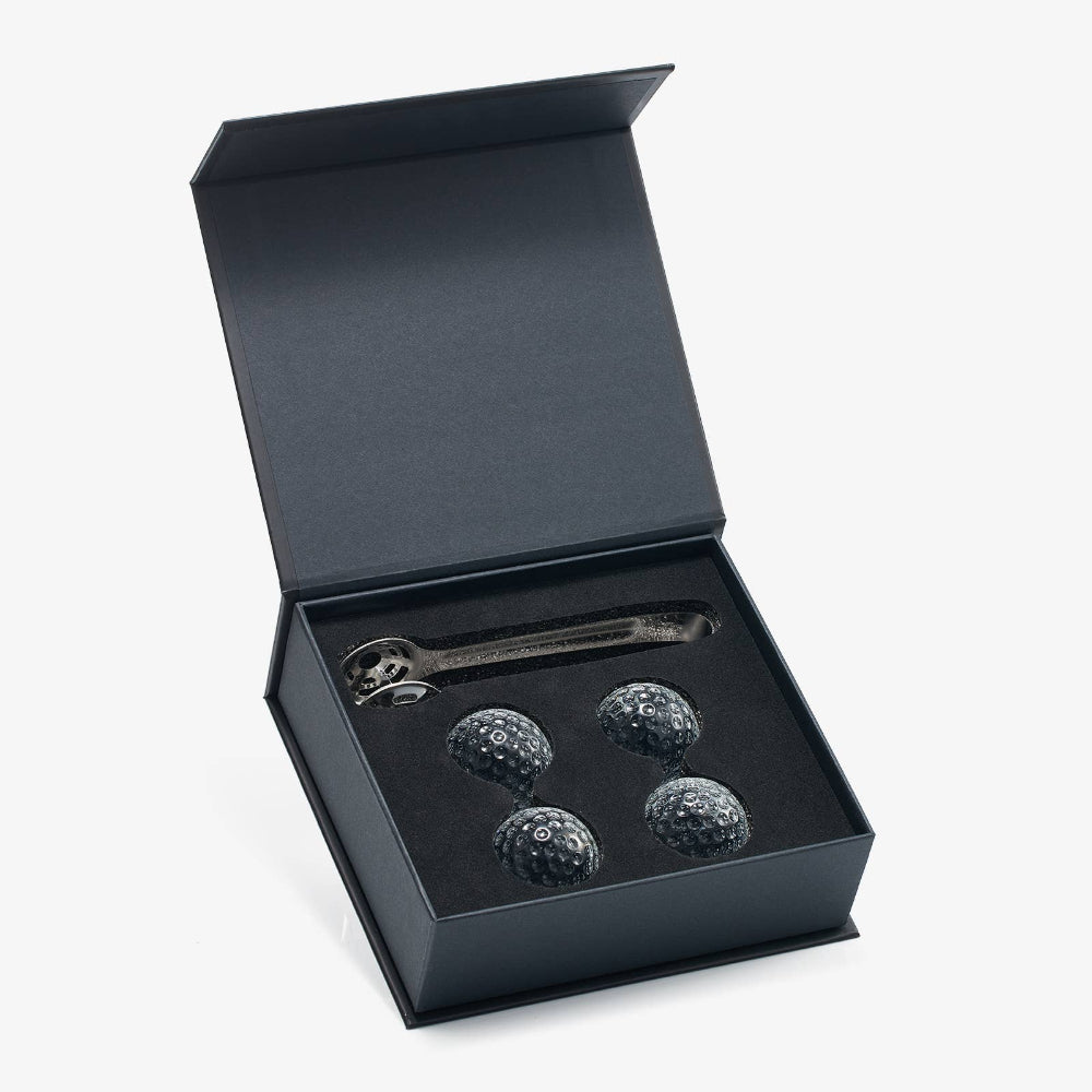 Open box displaying golf ball coolers and silver golf ball tongs