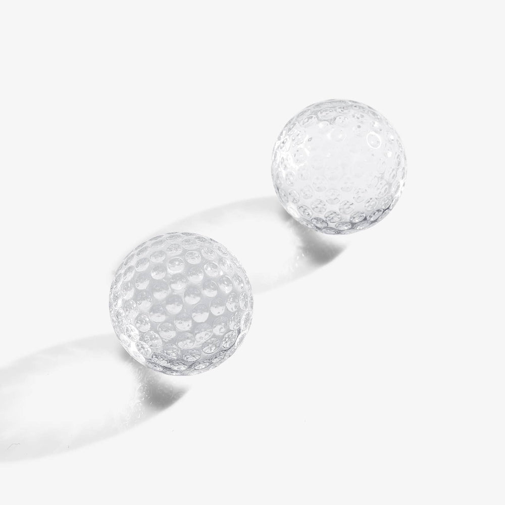 Two golf ball cooling cubes on white studio background