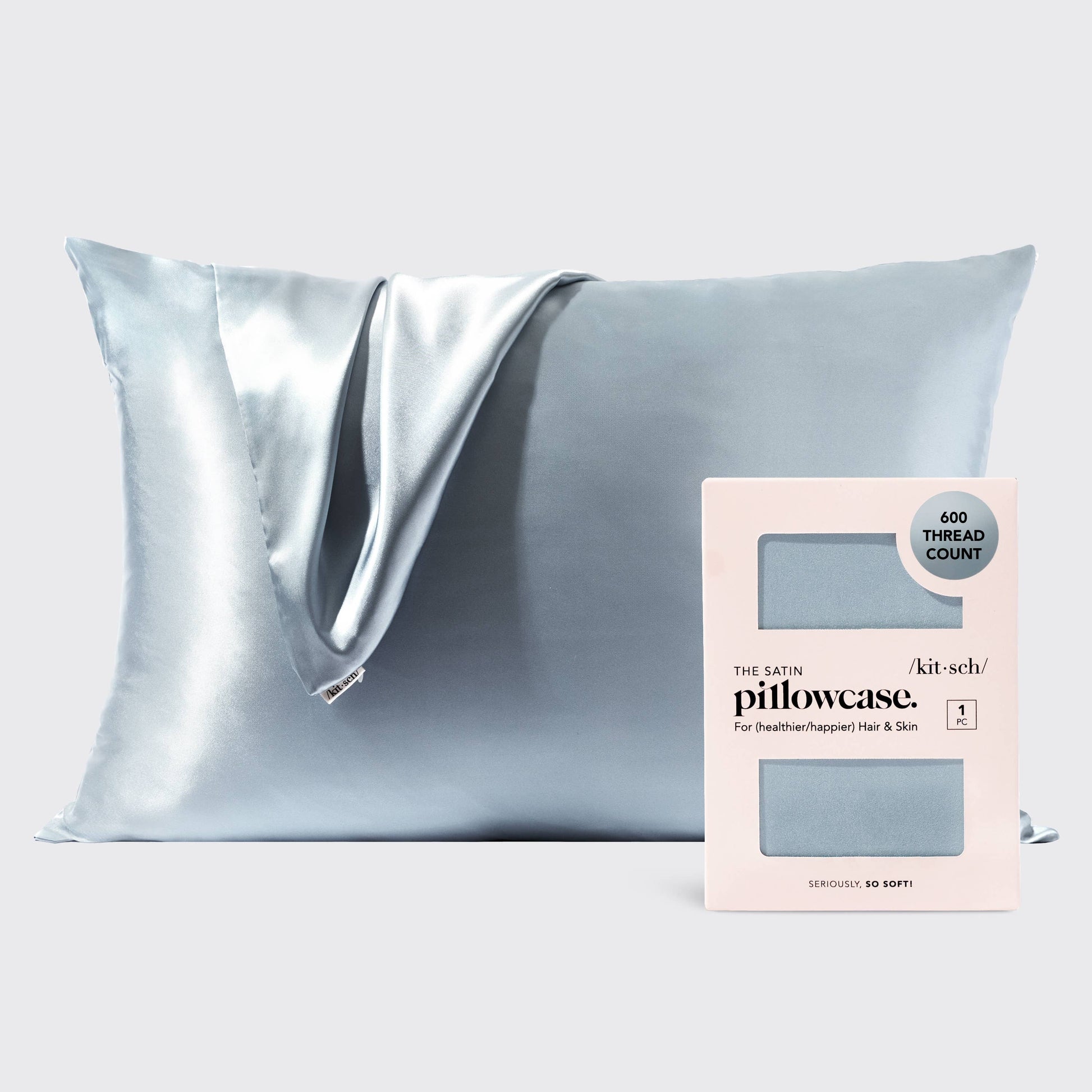 Kitsch haze blue satin pillowcase on a made bed
