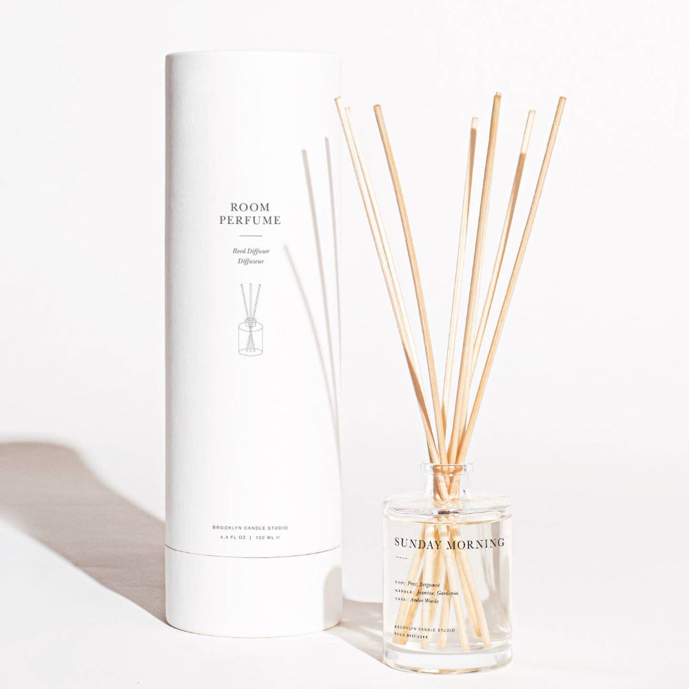 Brooklyn Candle Studio Sunday Morning reed diffuser bottle with rattan reeds on white