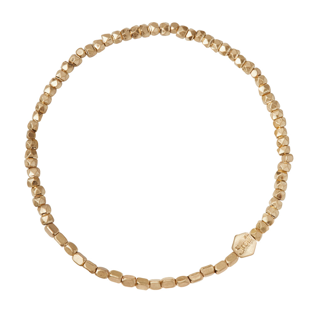 Scout Gold Mini Metal Stacking Bracelet in 3mm geometric brass beads with hexagon logo bead