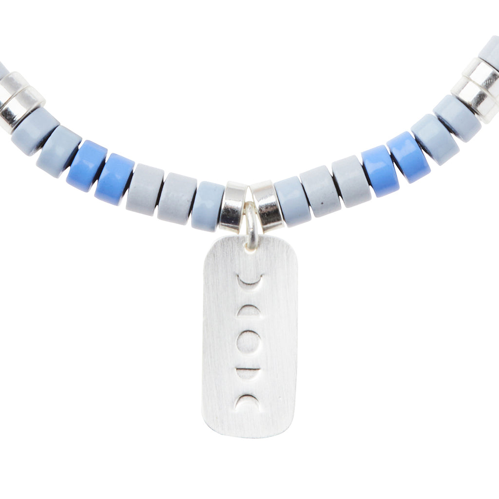 Scout Howlite Charm Bracelet close-up of metal charm featuring the Harmony design