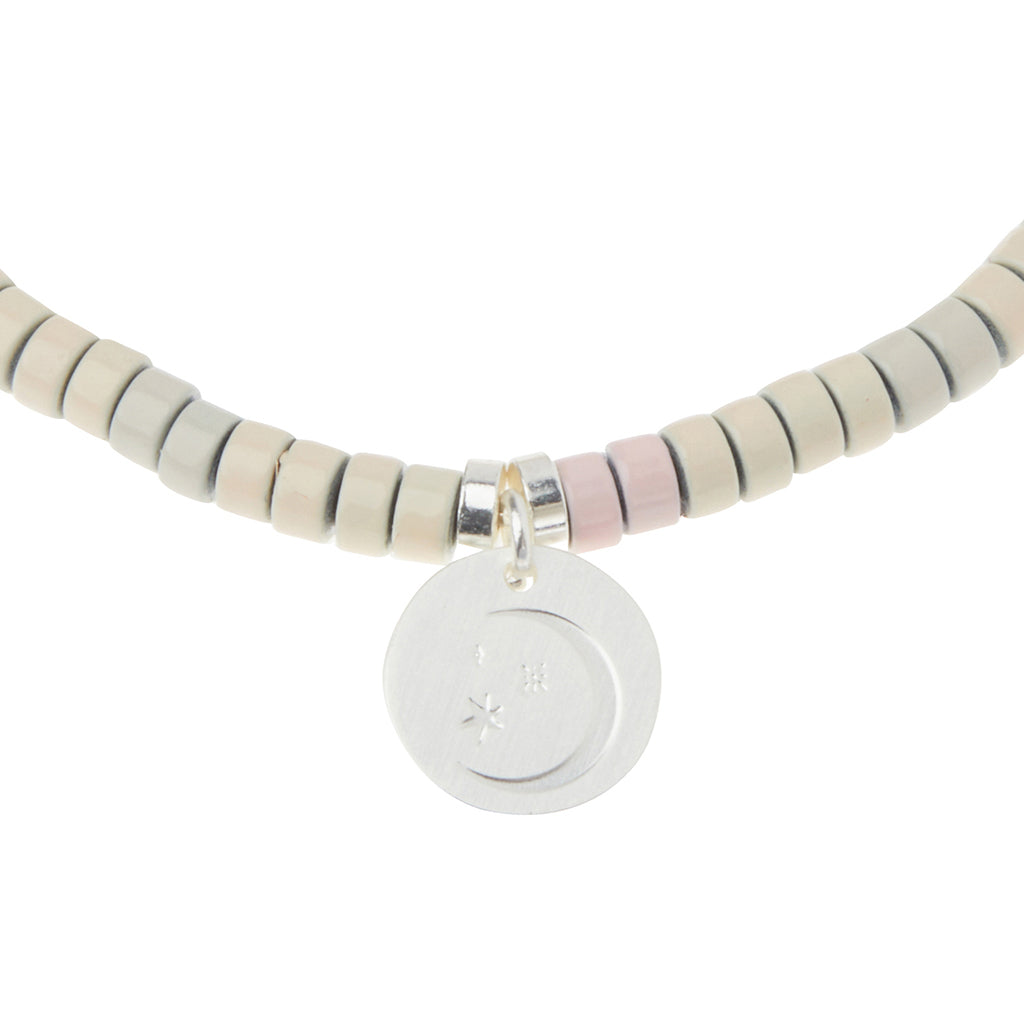 Scout Moonstone Charm Bracelet close-up of metal charm featuring the Balance design